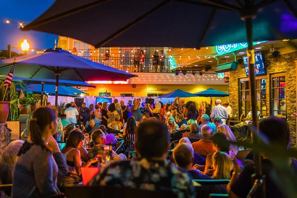 Coyote Bar & Grill — active evening patio, crowd, social energy · Carlsbad, CA