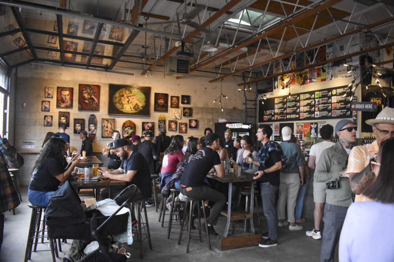 Fall Brewing Company — interior taproom, active crowd, art walls · North Park, San Diego
